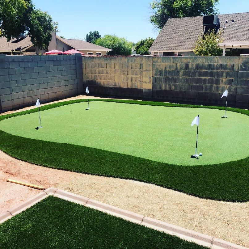 backyard-putting-greens-artificial-turf-with-brick-fence