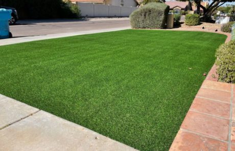 bright green artificial turf in the front yard of a house
