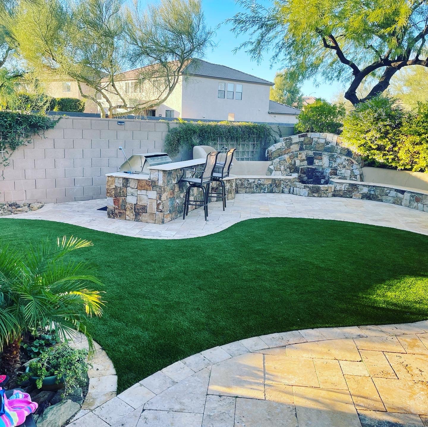 Backyard with artificial turf Arizona and fire pit