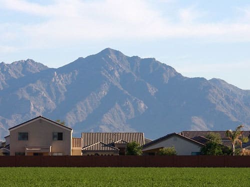 Avondale, Arizona Housing Tract Behind Farmer's Field with Mountains in Background