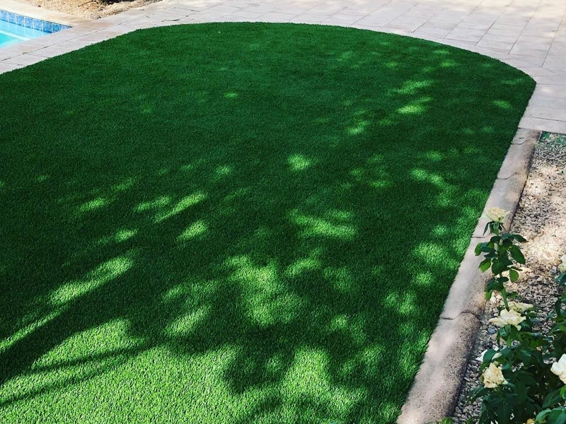 Bright green fake grass designed for drainage