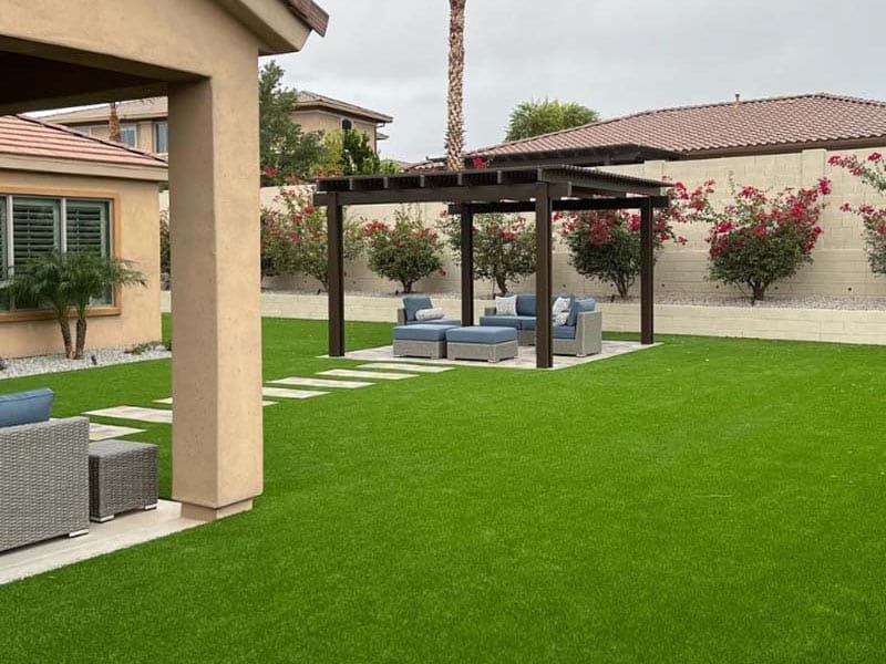 Backyard in Phoenix with artificial grass and pergola sitting area