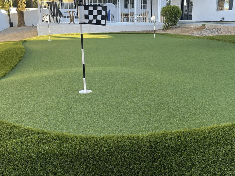 Backyard putting green with slopes and checkered flag