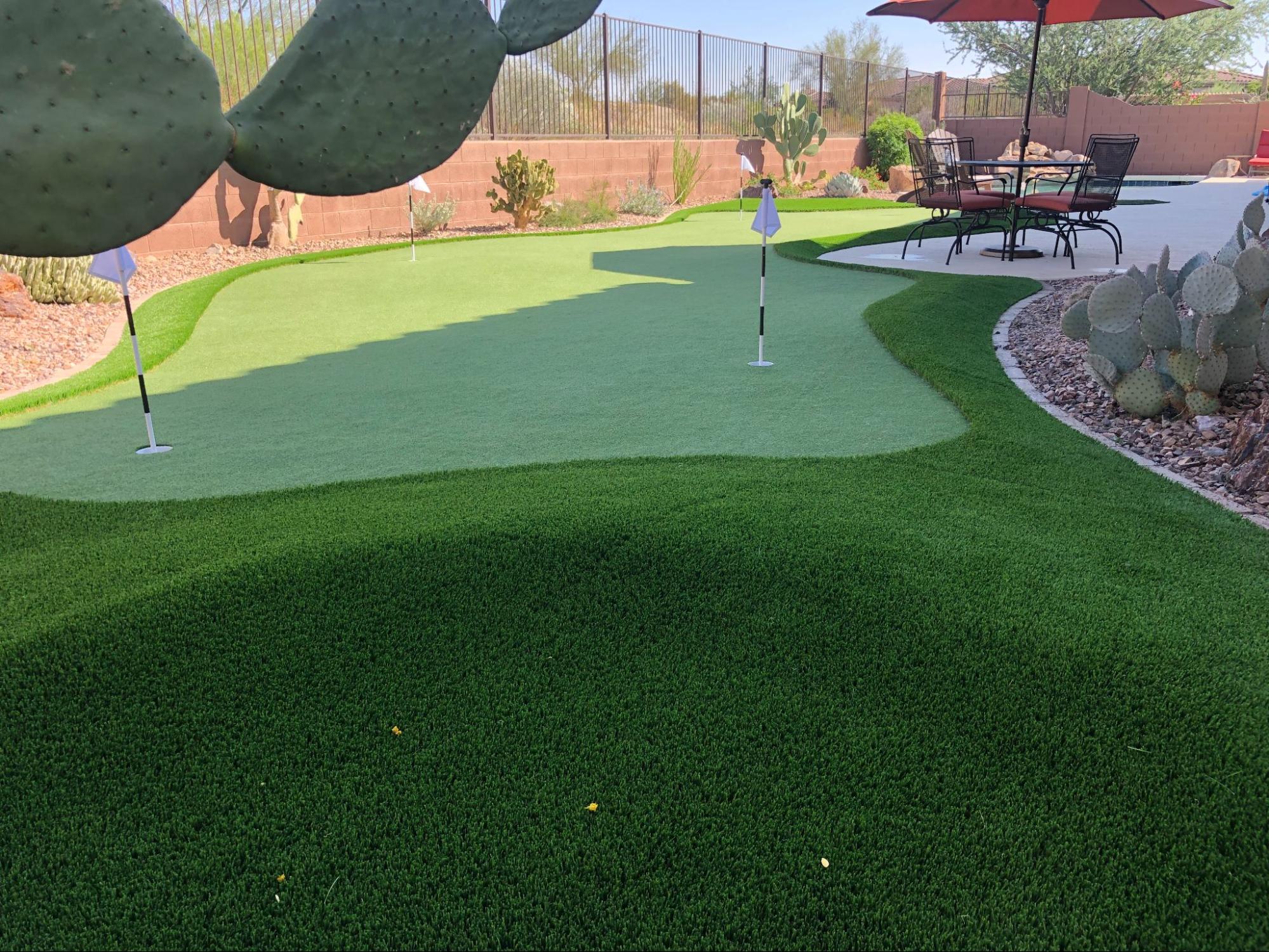 Artificial turf on slope with putting green in the back