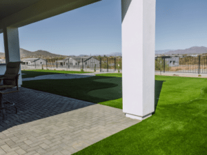 Pavers, artificial turf and putting green in a Phoenix backyard