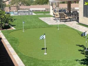 Arizona yard with multi-hold fake grass putting green