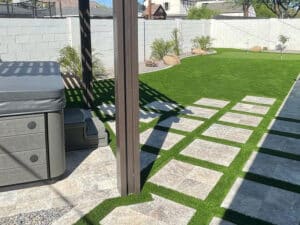 Backyard completed with pergola, pavers and fake grass